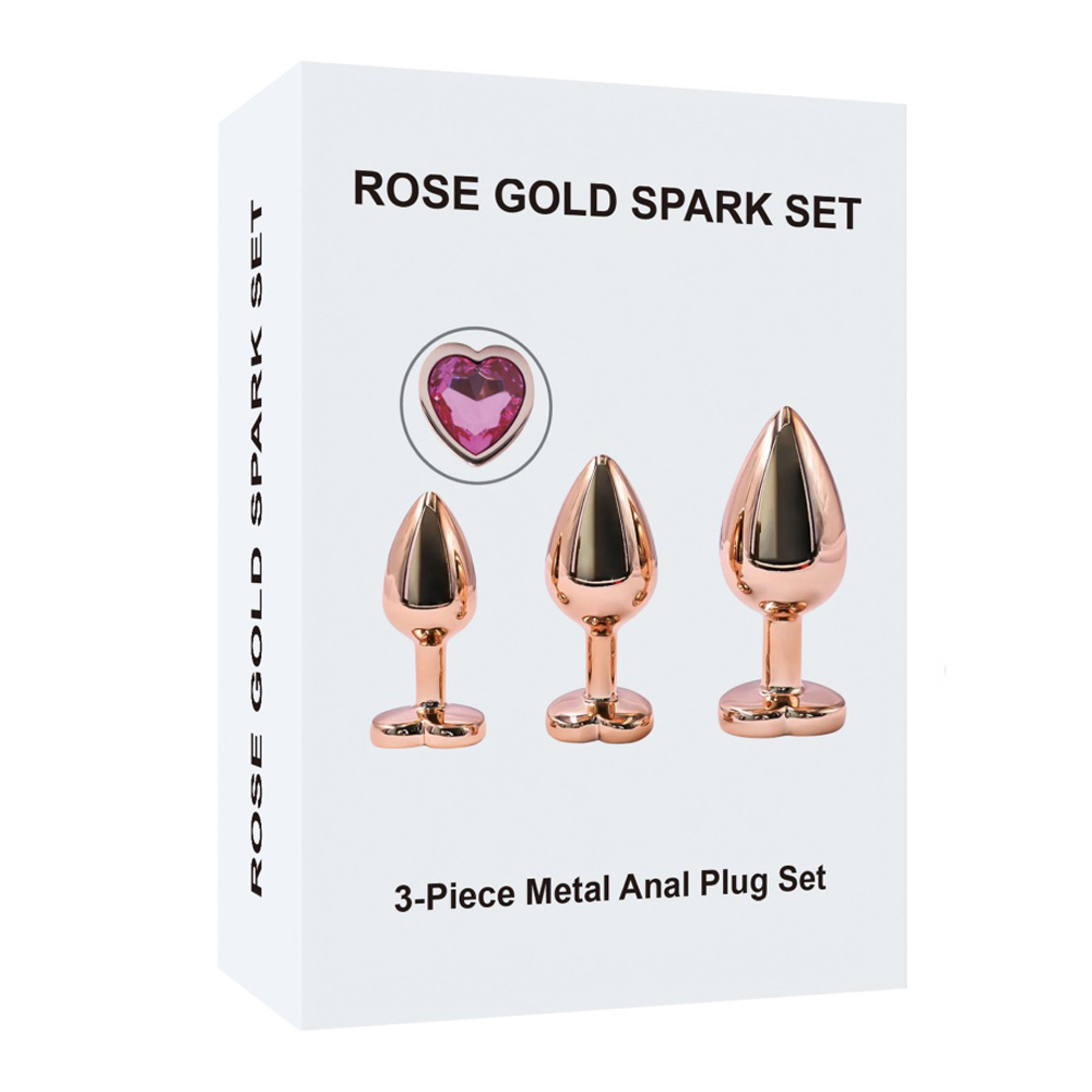 Kit di 3 plug anali in metallo dorato con brillante rosa a forma di cuore Kit di 3 plug anali in metallo dorato con brillante rosa a forma di cuore