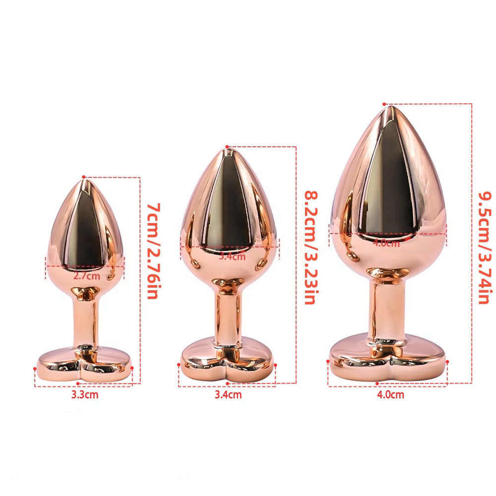 Kit di 3 plug anali in metallo dorato con brillante rosa a forma di cuore Kit di 3 plug anali in metallo dorato con brillante rosa a forma di cuore